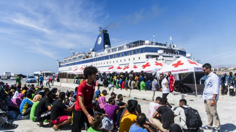 Pressure eases as Italian island begins migrant transfer to Sicily